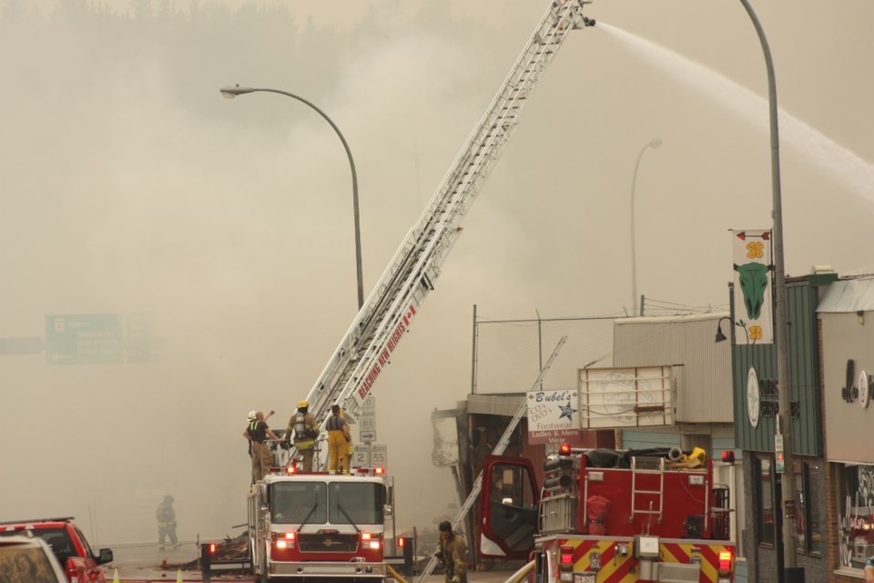 Firefighting crews battle a blaze at the historic Grand Union Hotel in Athabasca, where a fire began early in the morning of July 23. Lac La Biche came to help, supplying a ladder truck.