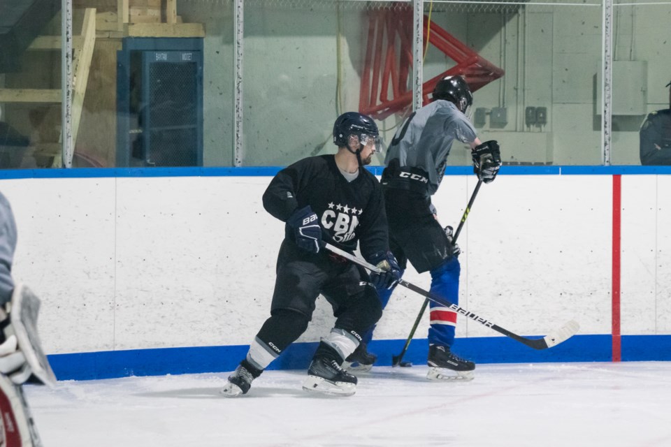 Members of the St. Paul RCMP (black jersey) play against members of the Mallaig Fire Department and Mallaig School during a charity game on Feb. 7 to raise money for the school and the food bank.