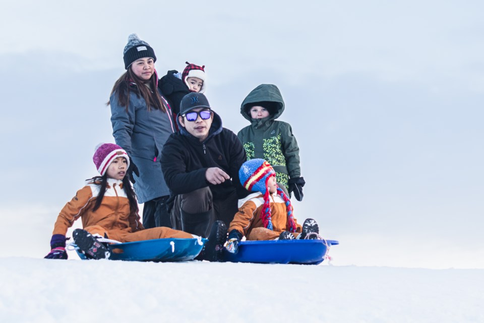 The Lirio family and friends sled down a snow-covered slope at the Lagasse Park in St. Paul on Dec. 23.