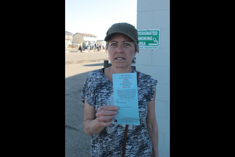 Laurie Mulgrew, a recent Kikino resident was at the rally to show support for human freedoms. She holds her own, homemade mask exemption card she created from global and federal information.