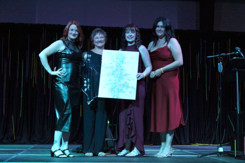 The Chamber of Commerce board presented President Lise Fielding with an Alex Janvier print for her service. From the left, Serena Lyons, Lise Fielding, Megan Wakefield, and Alyssa Mckibbon.