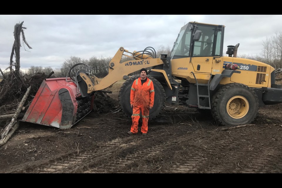 Dennis Lupul says his method of cleaning up brush piles puts the topsoil back on the land.
Submitted photo