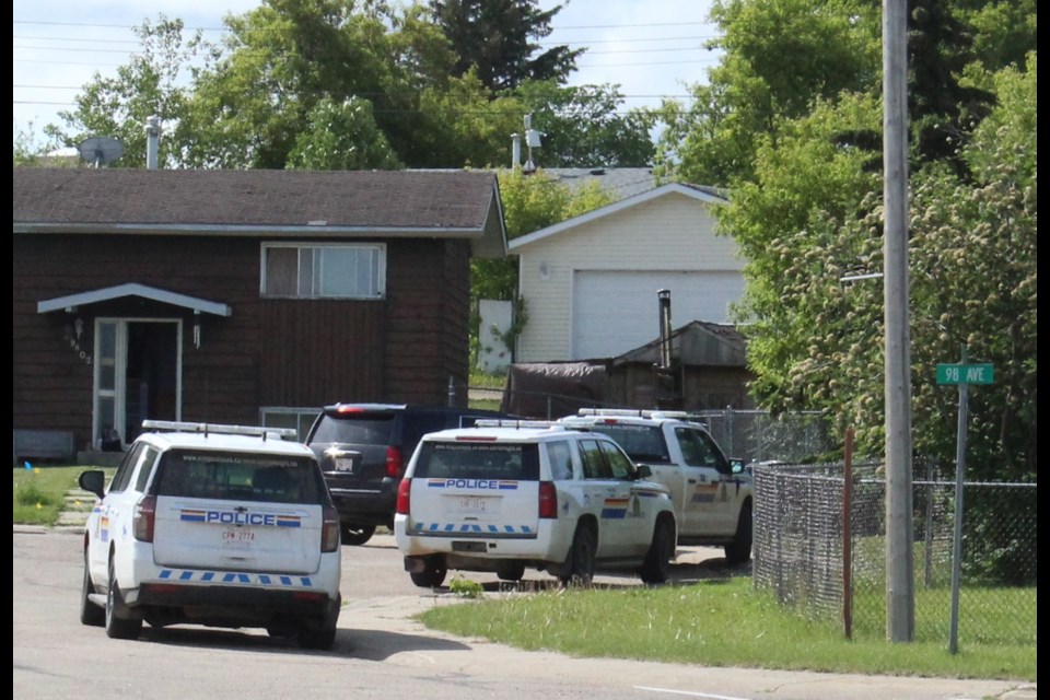 RCMP vehicles in a Lac La BIche cul-de-sac on 98 Avenue where an early morning tactical raid was carried out by RCMP. Another location, a room at a Lac La Biche hotel, took place at the same time.