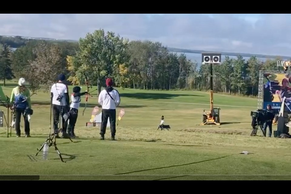 Archers in the medal finals take aim at an elevated target that backs onto the seventh fairway at the Lac La Biche Golf and Country Club.  Golf was suspended on the front nine holes of the 18 hole course for the weekend as the world's best archers competed.