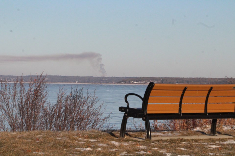 Smoke over the frozen water ... Smoke could be seen from the south shores of Lac La Biche lake on Sunday.   Image Rob McKinley
