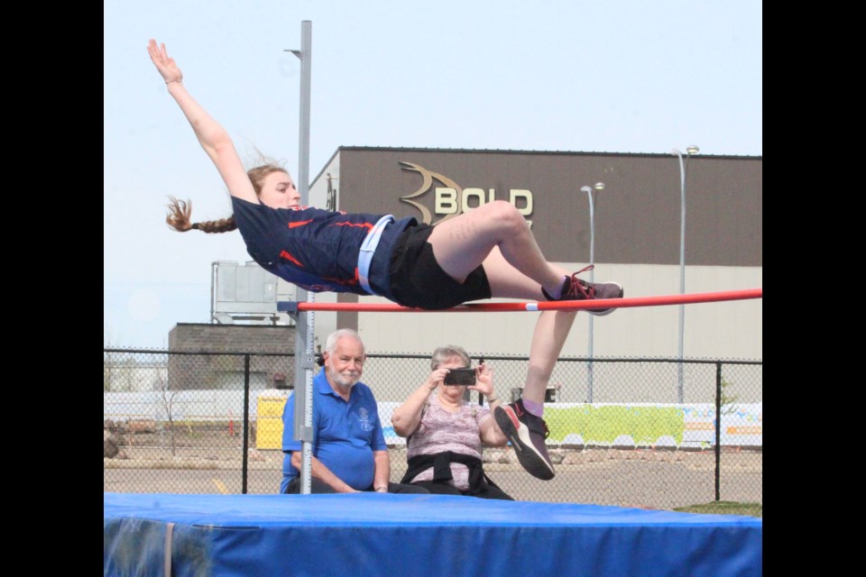 Peter and Liz Watson watch and take video of their granddaughter Cerys, an Ecole Beausejour athlete, in her high jump event during Thursday's Ward track and field event at Lac La Biche's Bold Center sports fields.