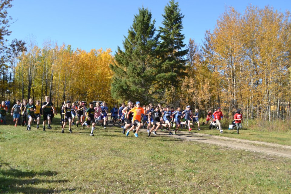 Runners hit the Ross Lake trail under bright blue skies in one of Thursday’s eight St. Paul Athletic Association Cross Country runs.