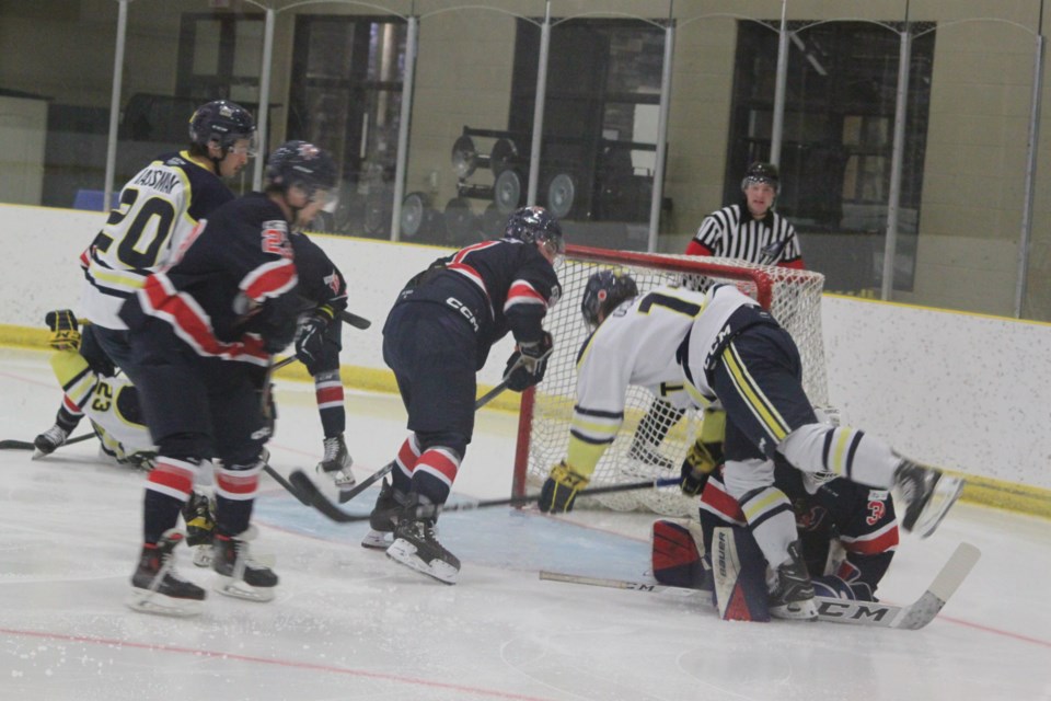 NAIT OOKs forward Bryce Osepchuk goes for a tumble as he falls over Portage College Voyageurs goaltender Alex Brousseau early in the first period of Saturday’s game at the Bold Centre. Chris McGarry photo.