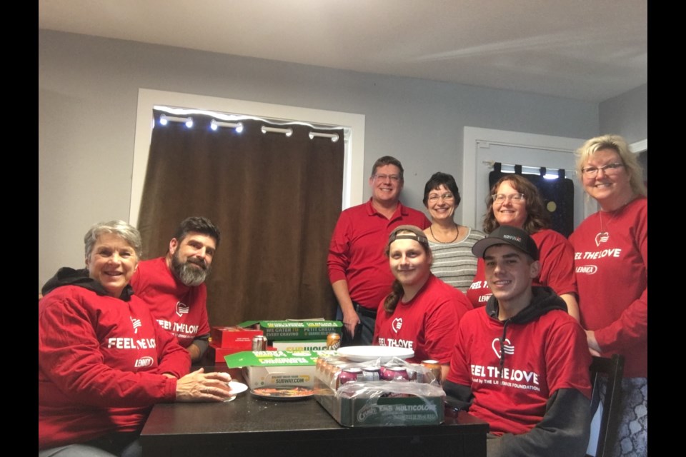 Volunteers with Precision Heat & Cool came to help out there 2024 winner of the Feel the Love program. Sitting, from the left: Shelley Dutertre, Brent Dutertre, Logan Church, and Hayden Nelder. Standing, from the left: James Hill, Linda Lauzon, Nancy Hite, and Tracy Ohland-Cintado.