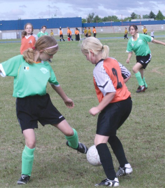 Julia Schmidt of the Bonnyville Limewires tries to dribble past a St.Paul Strikers player at the Wetlands U12 Tournament on Saturday morning.