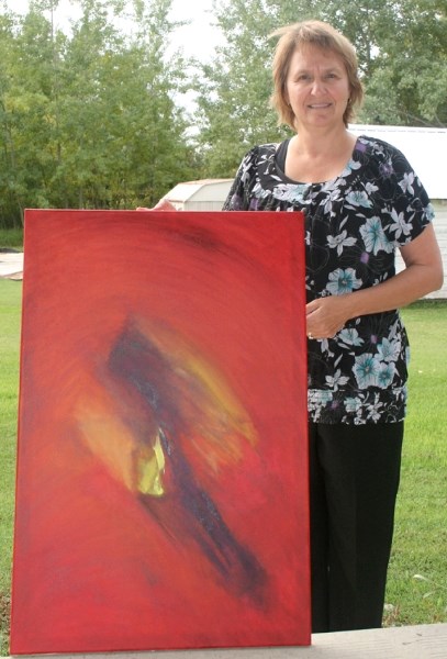 Local artist Rose-Marie Cameron shows off her recently completed painting, &#8220;Breakthrough,&#8221; which she describes as a &#8220;release.&#8221;