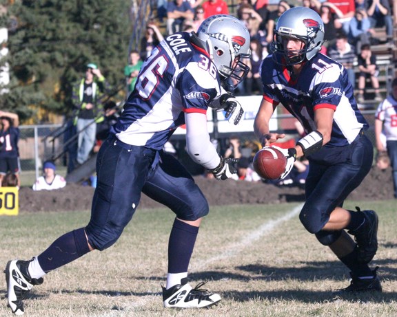 Voyageurs quarterback Jeremy Fagnan hands it off to teammate Doug Cole for a nice gain. But it was not enough, as the Cold Lake Royals came back to beat the Voyageurs in a