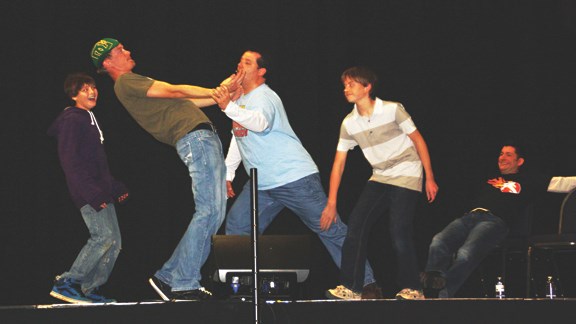 Volunteers move the comedians into a funny pose at the Panic Squad clean comedy show Oct. 23 at the Centennial Centre.