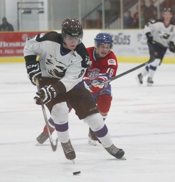 Cold Lake Ice forward Chad Hurtubise carries the puck up the ice in NEAJBHL action against the St. Paul Canadiens. The Ice came from behind to defeat St. Paul 6-4.