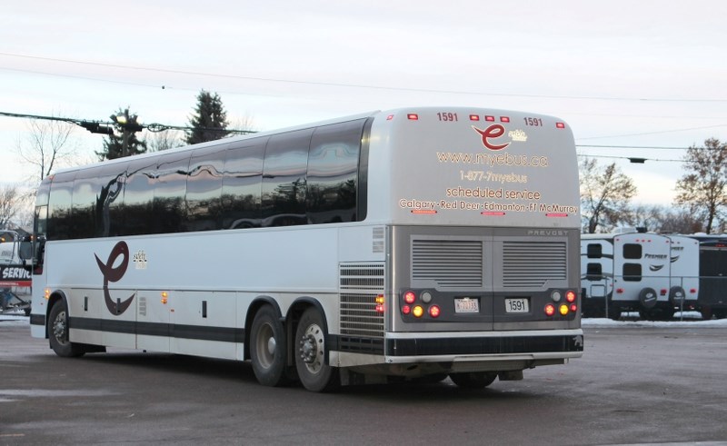 A Red Arrow motorcoach sitting outside the Bonnyville 7-11.