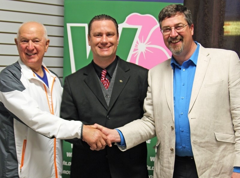 Reeve Ed Rondeau (left) and Bonnyville Mayor Gene Sobolewski (right) celebrate with new MLA Scott Cyr after he won the local election.