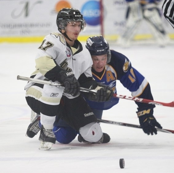 Pontiacs forward Chandler Klein wins a scrummed faceoff against Fort McMurray&#8217;s Shawn Weber.