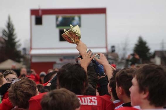 The Renegades reach for the league championship trophy they had just won against the Lloydminster Colts