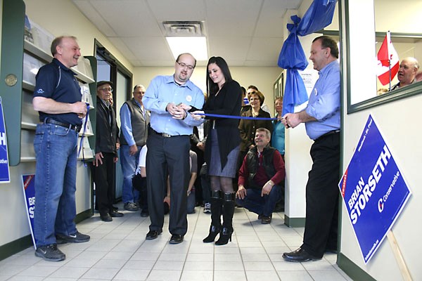 Incumbent MP Brian Storseth cuts the ribbon with his wife Amel at the Conservatvie Party campaign headquarters on 50th Avenue in St. Paul on Wednesday. Storseth is flanked by 