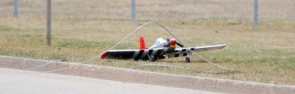 A gas-powered model plane flew off course and crashed into an overhead powerline near the Regional High School on Monday leaving nearby residents temporarily without power.