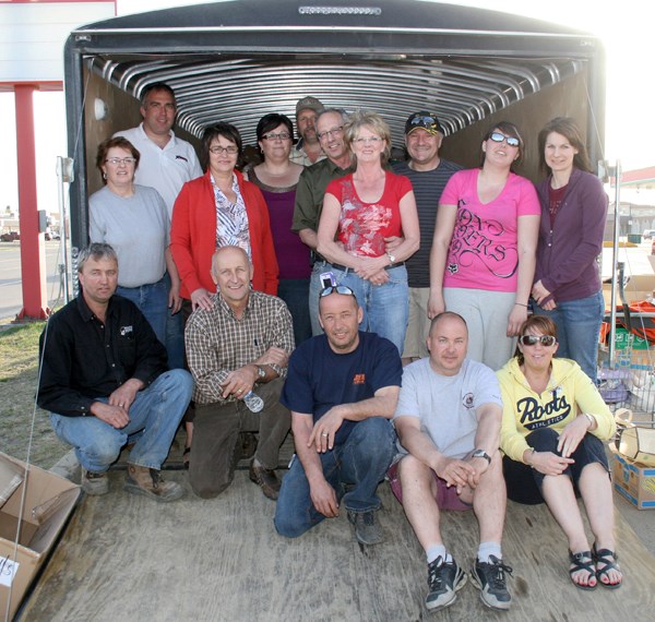 Several St. Paul volunteers helped sort and pack items for shipping to the Slave Lake relief effort on May 16. Back row left: Eugene Labant, Rosanne Corbiere, Clem Corbiere,