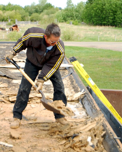 Therien Community Hall president John Brooker puts in time and hard work on the building&#8217;s roof. Brooker hopes to finish exterior repairs in the next couple months.