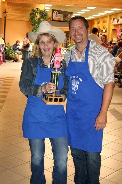 County of St. Paul members Janice Fodchuk and Bryan Bespalko hold up their first place trophy at the chili cook-off contest held at the St. Paul Co-op Mall on Thursday.