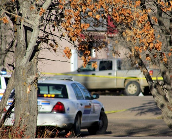 RCMP officers investigate the site where a male in his 20s died after an alleged altercation with two males in Glendon on Wednesday morning.