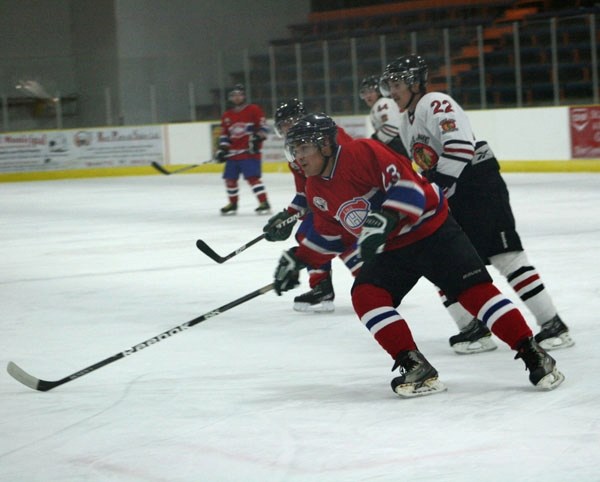 Canadians Junior B leading scorer Brandon Cantre looks to get possession of the puck, followed closely by the Warriors&#8217; Jordan Moosewah, in St. Paul on Saturday at the