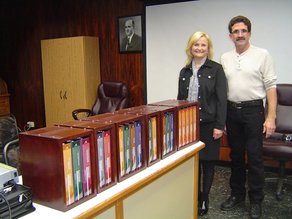 Mayor Glenn Andersen and consultant Roxane Laslo check out the Town of St. Paul&#8217;s 19-binder strong set of operating manuals, at the presentation of the finished product 