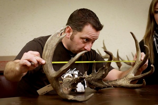 Bryan Bespalko measures a set of antlers during the annual Buck of the Season event, hosted at the Ashmont Agriplex on Saturday.