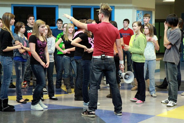 Students at Ecole du Sommet are directed by the host of the francophone show Radart, Michel Benec, in preparation for a flash mob.