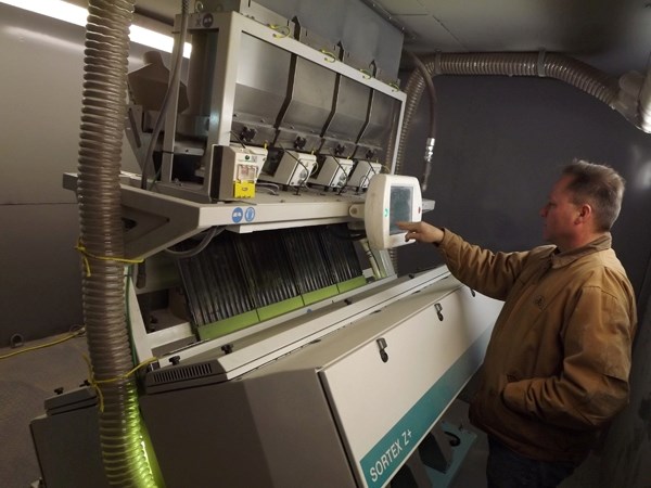 Municipal Seed Cleaning Plant manager Ron Wirsta stands at the newest piece of equipment at the plant, a colour sorter.