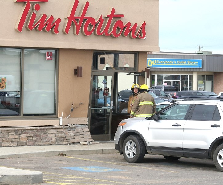 A vehicle drove into the side of the Tim Hortons building on Oct. 30. The driver, along with two people inside the building, were treated at the local hospital.