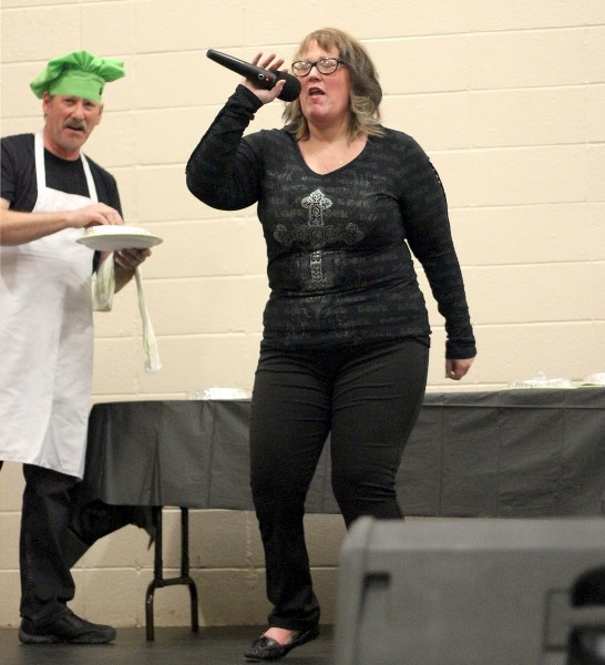 Dorinda Degagne, one of six contestants at Killer Karaoke on Saturday night, attempts to sing Born To Be Wild through a mouth full of anchovies at the St. Paul Splash Park