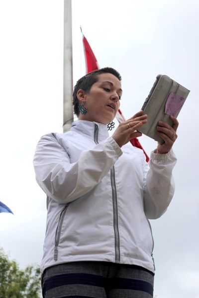 Colleen Hughes, a wife of a local RCMP member, reads a poem in honour of the fallen RCMP officers in Moncton, N.B., at a gathering at the local detachment last Friday night.