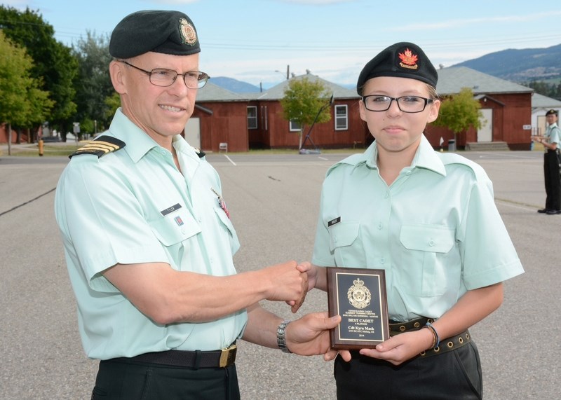 Cadet Kyra Mack is presented with the plaque recognizing her achievement as the best cadet in her platoon during the three-week Basic Leadership Course at Vernon Army Cadet