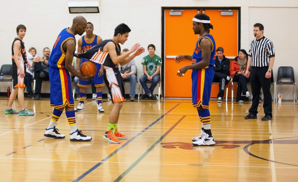 The Harlem Crowns made an appearance at the St. Paul Regional High School on March 3. Pictured is Regional player Romeo Cardines having a ball shoved into his jersey by a