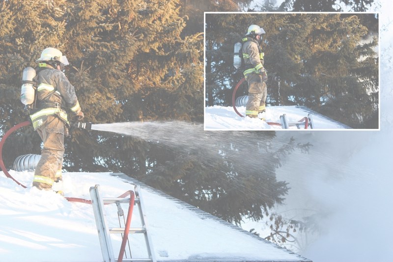 Firefighter Ben Burton works to extinguish a fire on Dec. 28. The temperature outside felt like -35C.