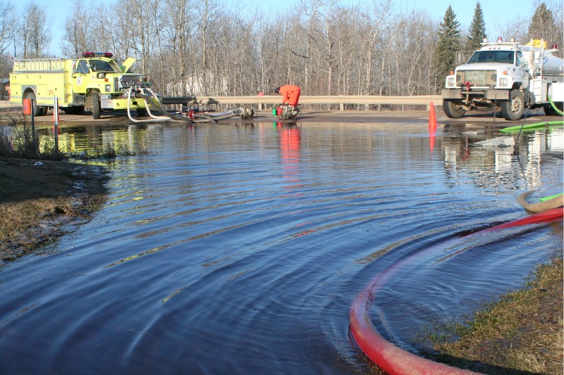 Firefighters worked around the clock to pump the water out of Plamondon after a blocked culvert caused spring run-off to flow through the town, flooding several homes in the