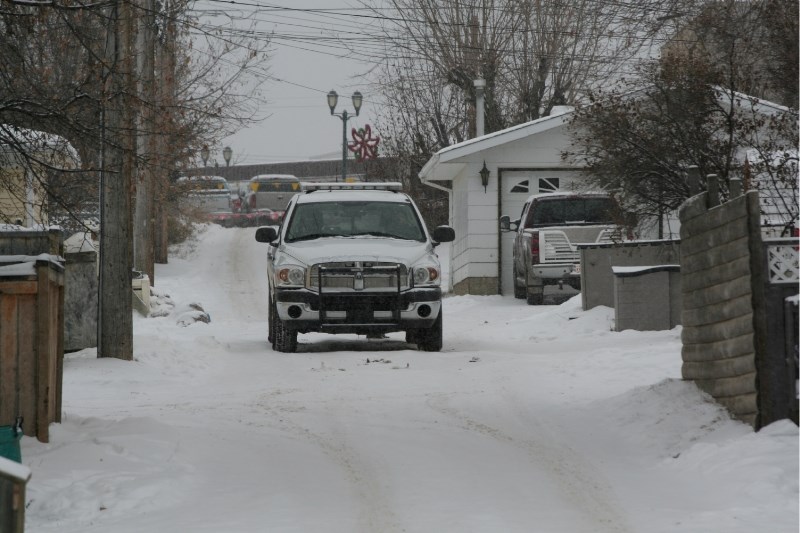 A Lac La Biche County peace officer keeps watch on the back alley where Hector Cardinal was found dead Dec. 21, 2009.