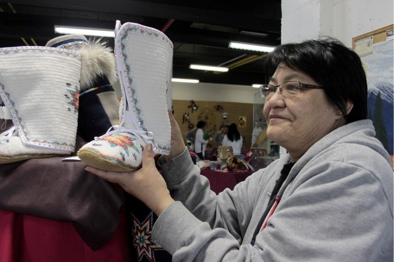 Margaret Erasmus, who is from the Kikino Métis Settlement, holds a pair of her hand-made boots at Portage College&#8217;s Native Arts showcase last Friday. Erasmus spent 280