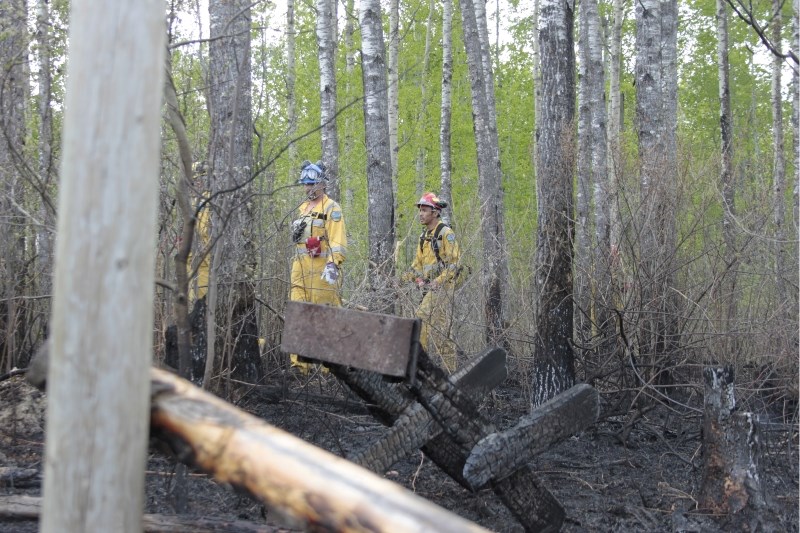 Alberta ESRD firefighters respond to a fire near a home in the Square Lake subdivision northeast of the Hamlet of Lac La Biche last Monday afternoon. The fire was put out