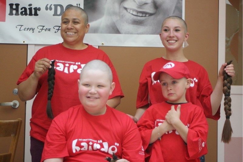 Back row (l-r): Lori Lemay, Chelsea Lachowich. Front row (l-r) Gavin and Arden Kozakevich. The four volunteers managed to raise a total of $8,670 for the Great Canadian Hair