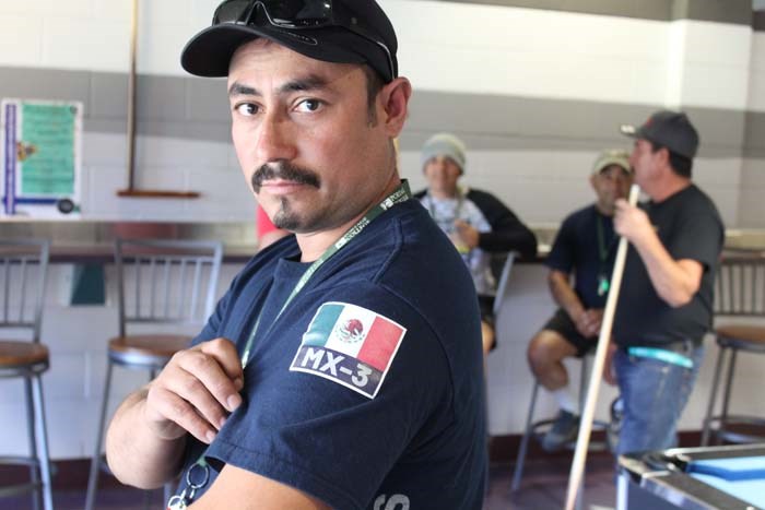  Crew member Everardo Zuniga shows off the Mexican emblem on his sleeve