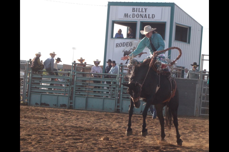 Lac La Biche's Jaron Johnson was in a shirt and tie, ridin' high on bronc Black Mocassin during Friday night's running of the Billy McDonald Memorial Rodeo at the Lakeland Ag Grounds rodeo arena. Chris McGarry photo. 