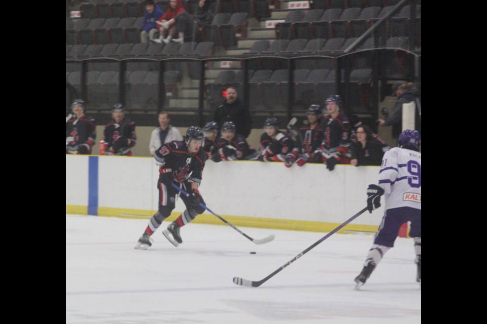 Lac La Biche Lakers player Jaron Shirt attempts to get the puck past Edson Eagles defenseman Gavin Kolbuc during Friday’s game at the Bold Center which the Lakers won 5-4. Chris McGarry photo. 