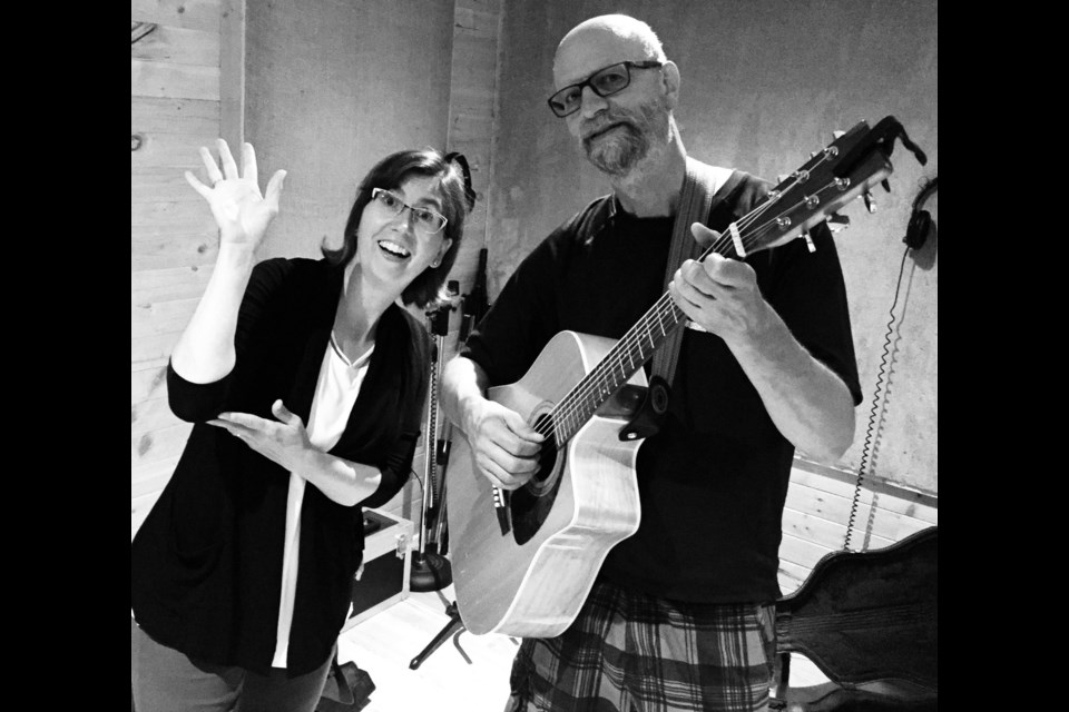 Joanne Wicker, who is retiring as the children's programmer of the Stuart MacPherson Library in Lac La Biche after 16 years, with Paul Shaw, a local musician who performs for children's programs at the library and is known as 'Pappa Paul.' Submitted photo. 