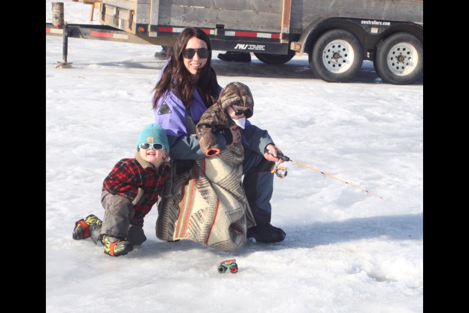 Karen Charest and her children, Walker and Weston, cast a line in the ice at the second annual Elks on Ice event. The day of fun ice fishing, which is organized by the Lac La Biche Elks Lodge #470, took place on Lac La Biche Lake next to Sir Winston Churchill Provincial Park on March 8. Chris McGarry photo.