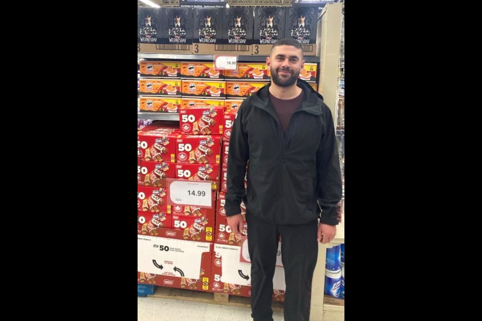 Khalil Abougouche of Abougouche Brothers grocery store in Lac La Biche stands in front of a shelf filled with boxes of Halloween candy and chips. Chris McGarry photo. 